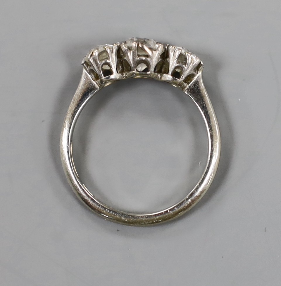 An 18ct, plat and three stone diamond ring, size K, gross weight 2.9 grams